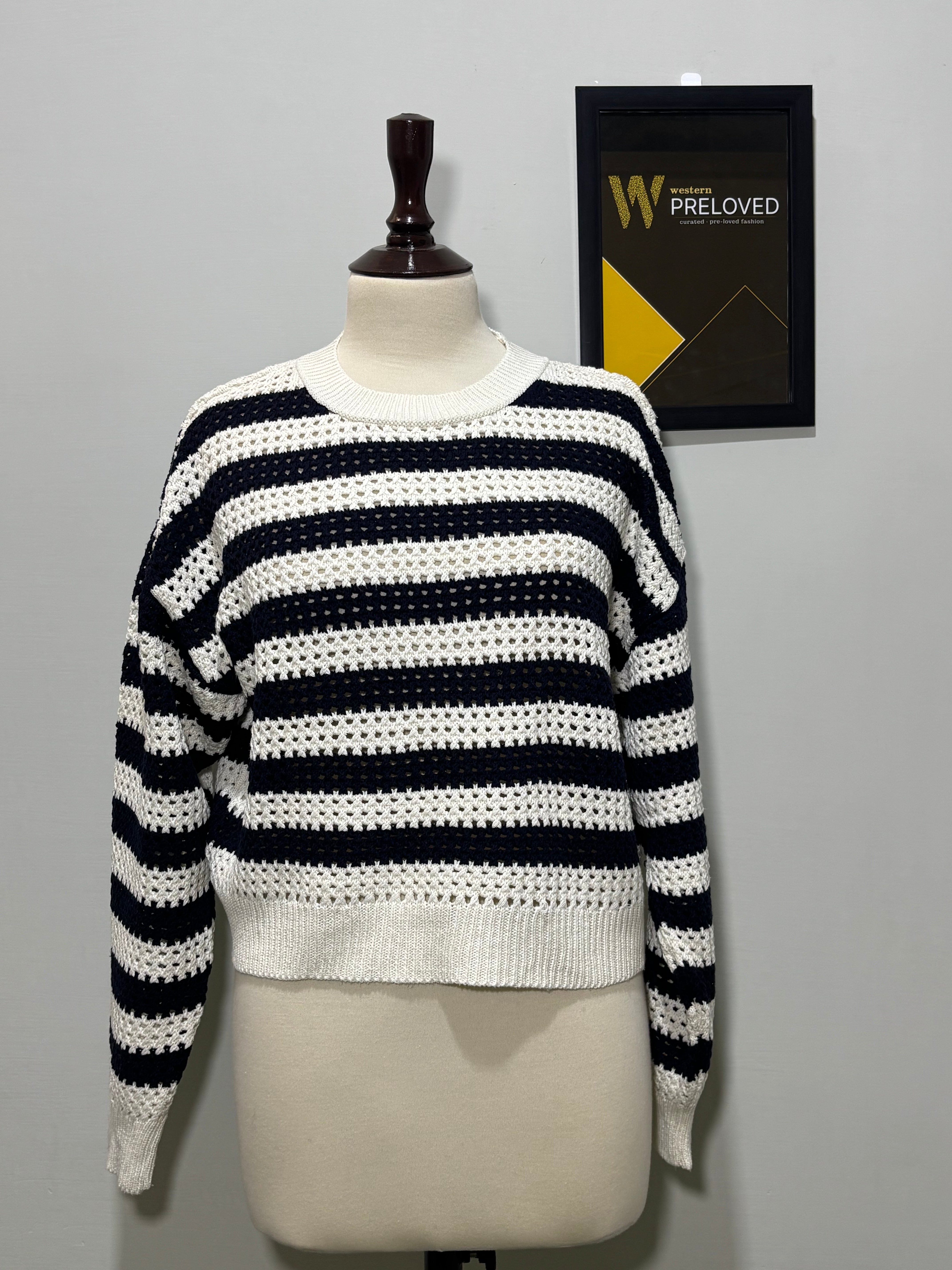 Navy blue and cream striped openwork drop-shoulder top on mannequin
