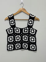 Black and white wide-strap openwork crop top on hanger