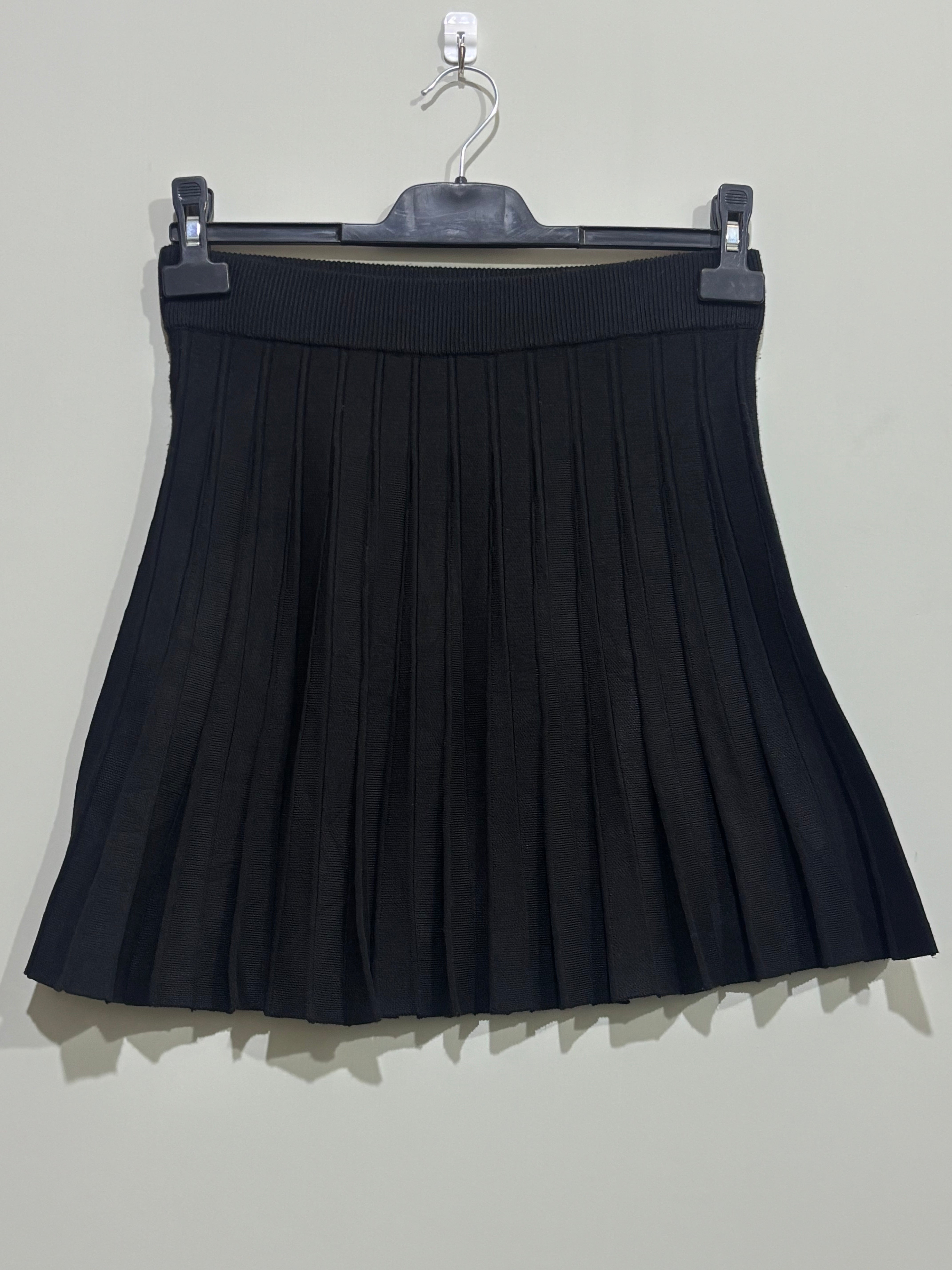 Black pleated A-line mini skirt with wide ribbed waistband
