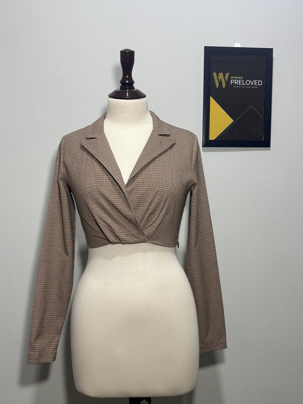 Brown and black checked lapel wrap-style crop top front view