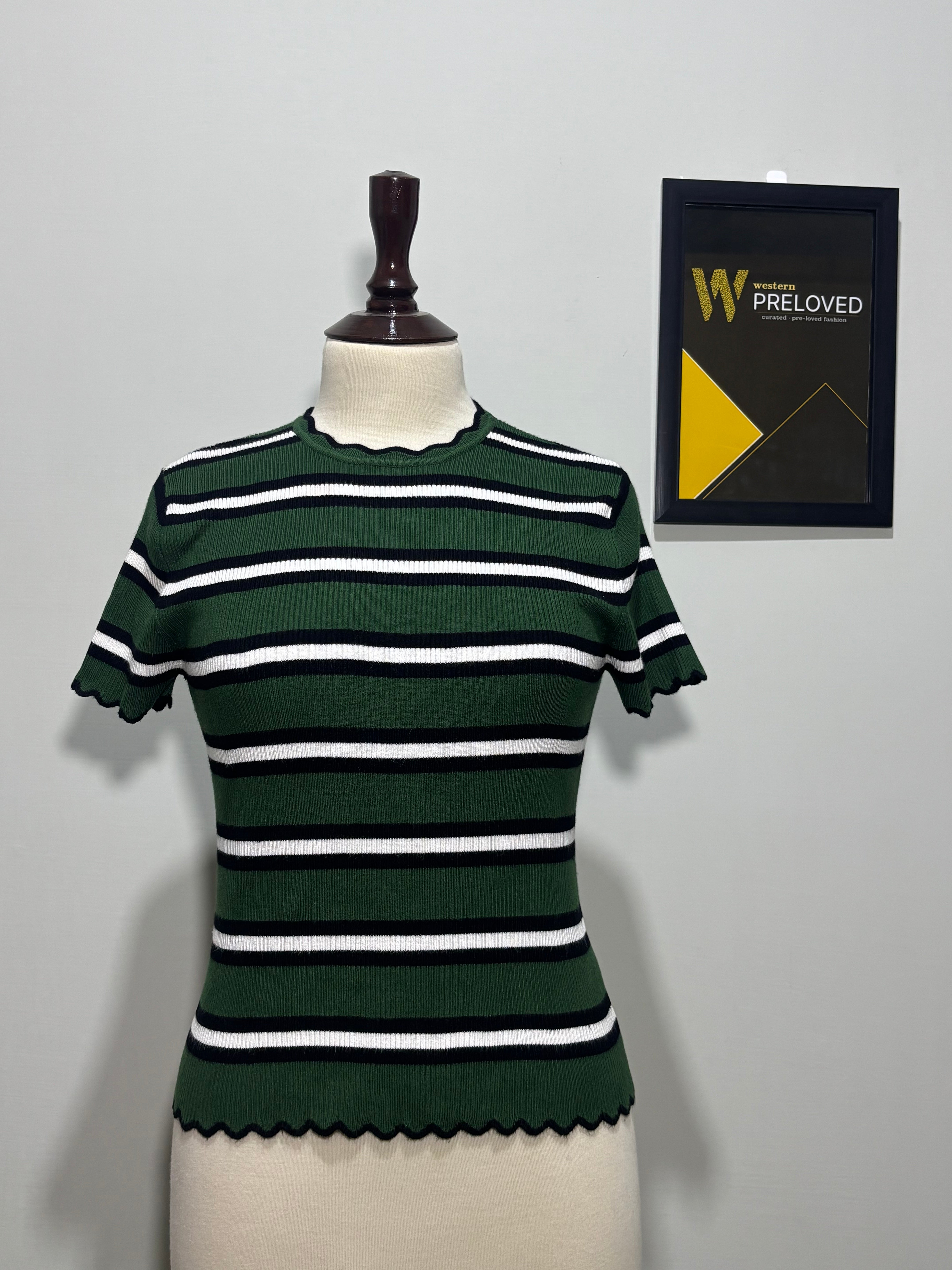 Dark green black and white striped scallop-trim top on mannequin