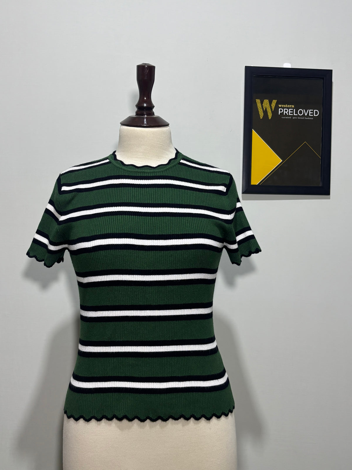 Dark green black and white striped scallop-trim top on mannequin
