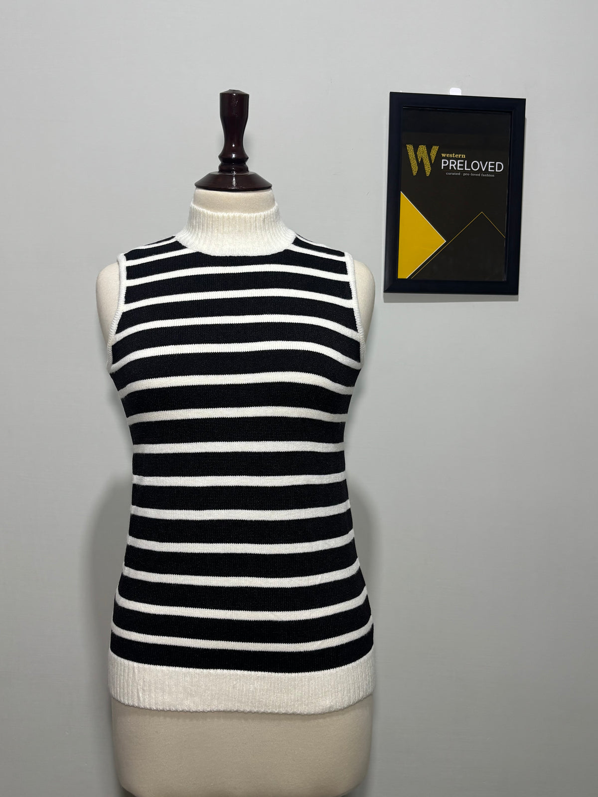 Black and white striped high-neck sleeveless top on mannequin