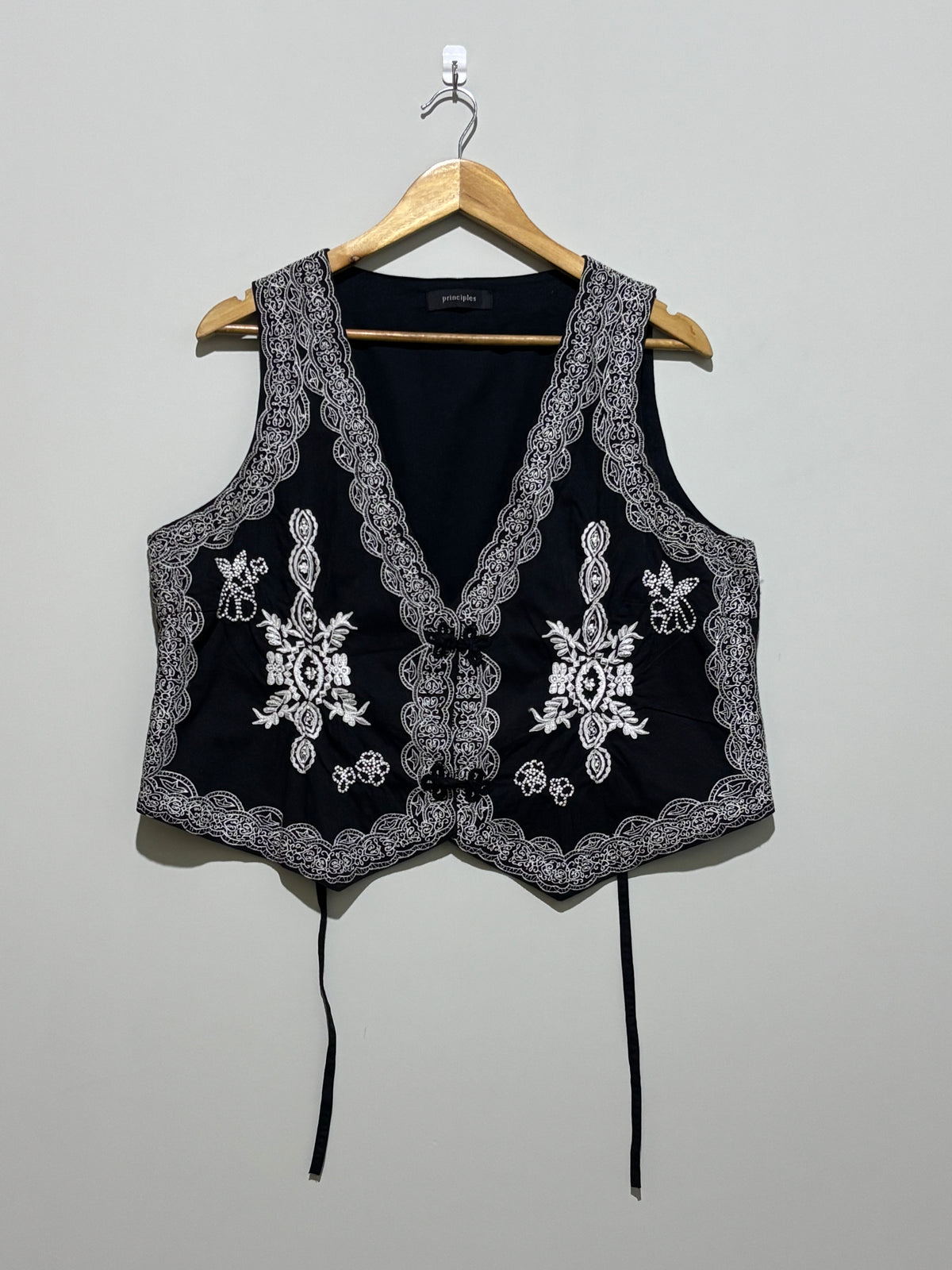 Black waistcoat with contrast floral embroidery and ornate borders