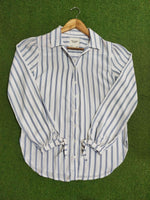Striped shirt on a hanger against a green background