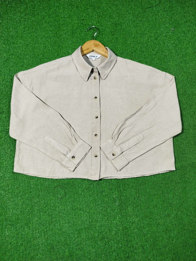 Beige shirt on a hanger against a green background