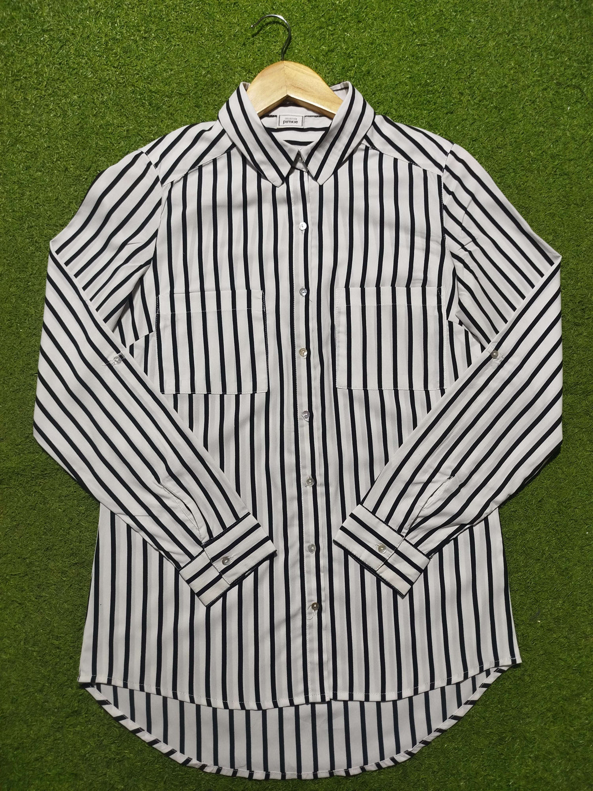 Black and white striped shirt on a green background