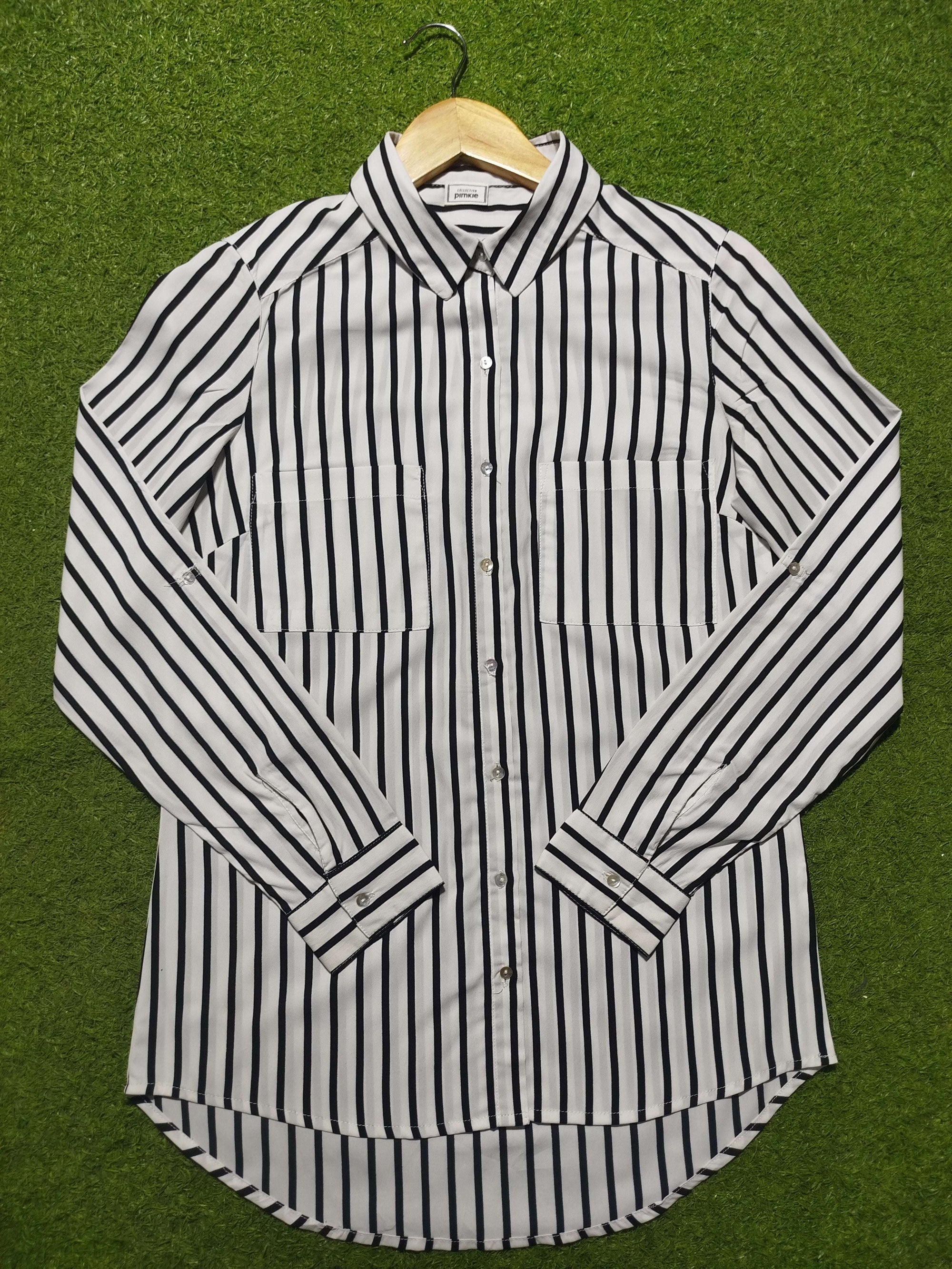 Black and white striped shirt on a green background