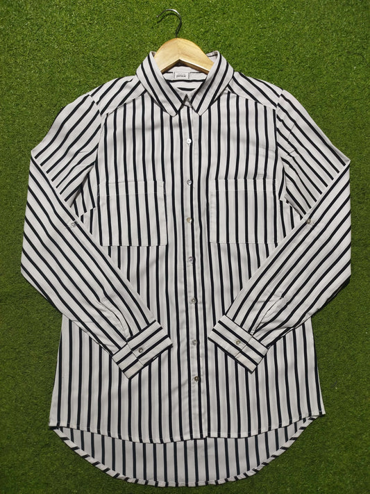 Black and white striped shirt on a green background