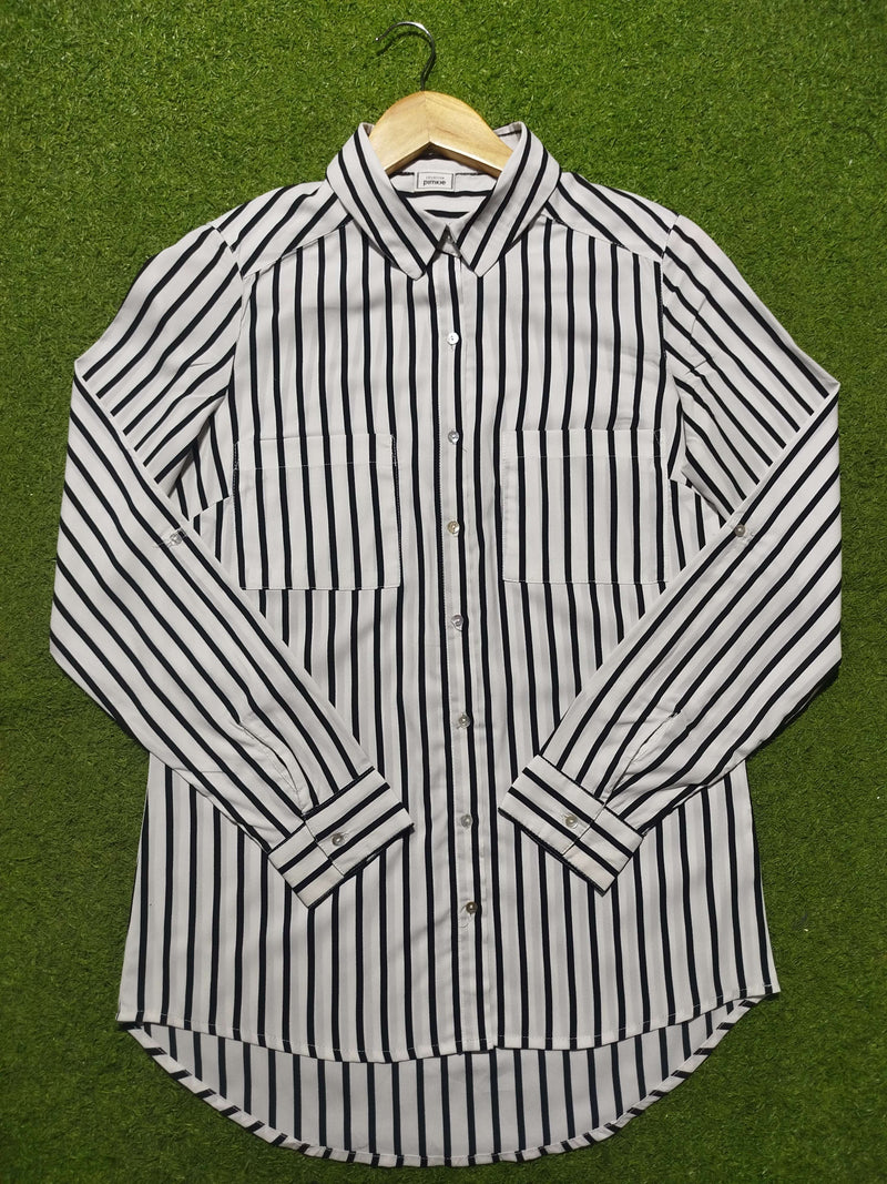 Black and white striped shirt on a green background