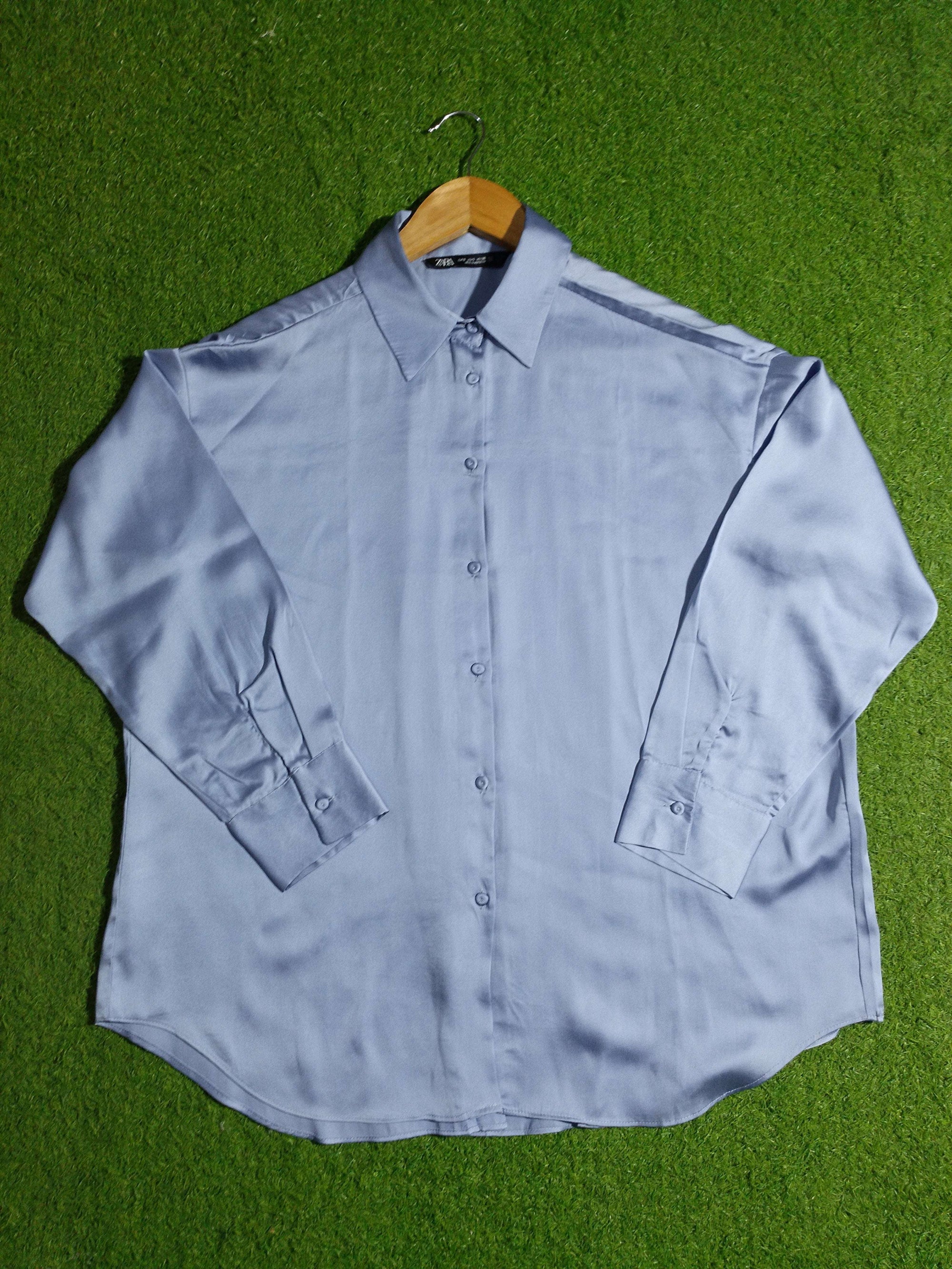 Light blue shirt on a green grass background