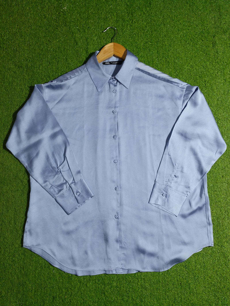 Light blue shirt on a green grass background