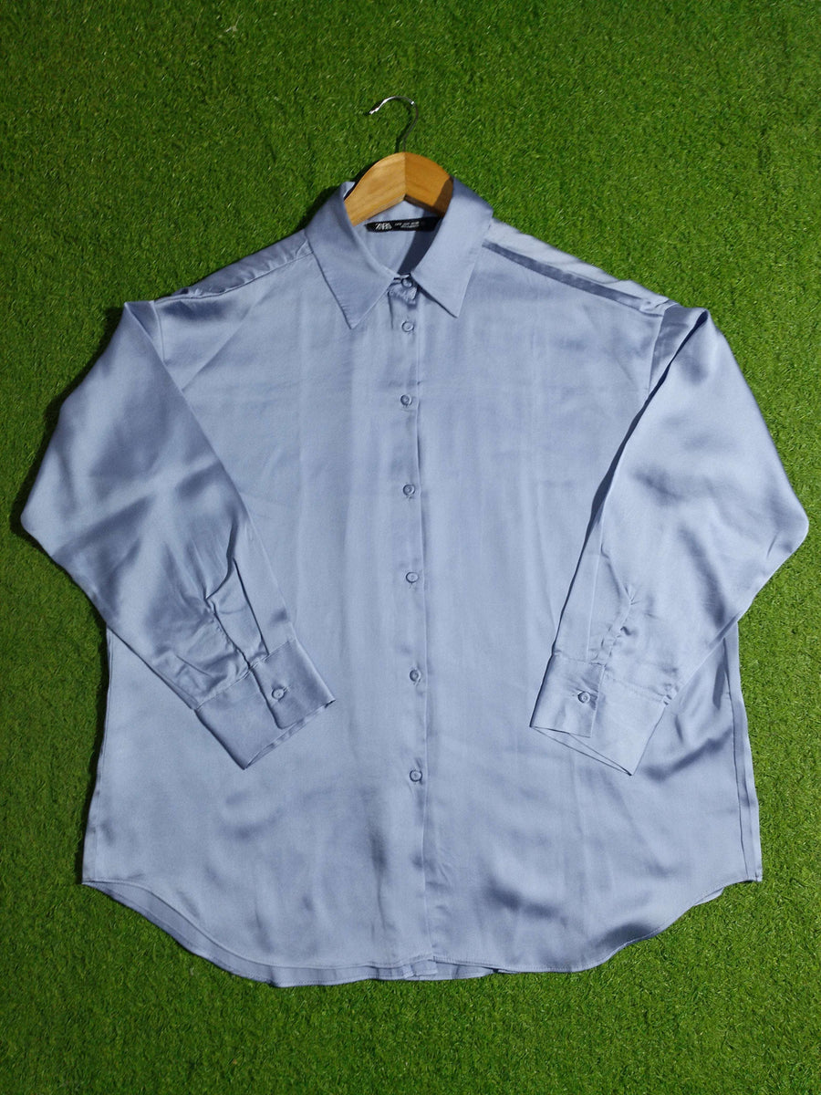 Light blue shirt on a green grass background