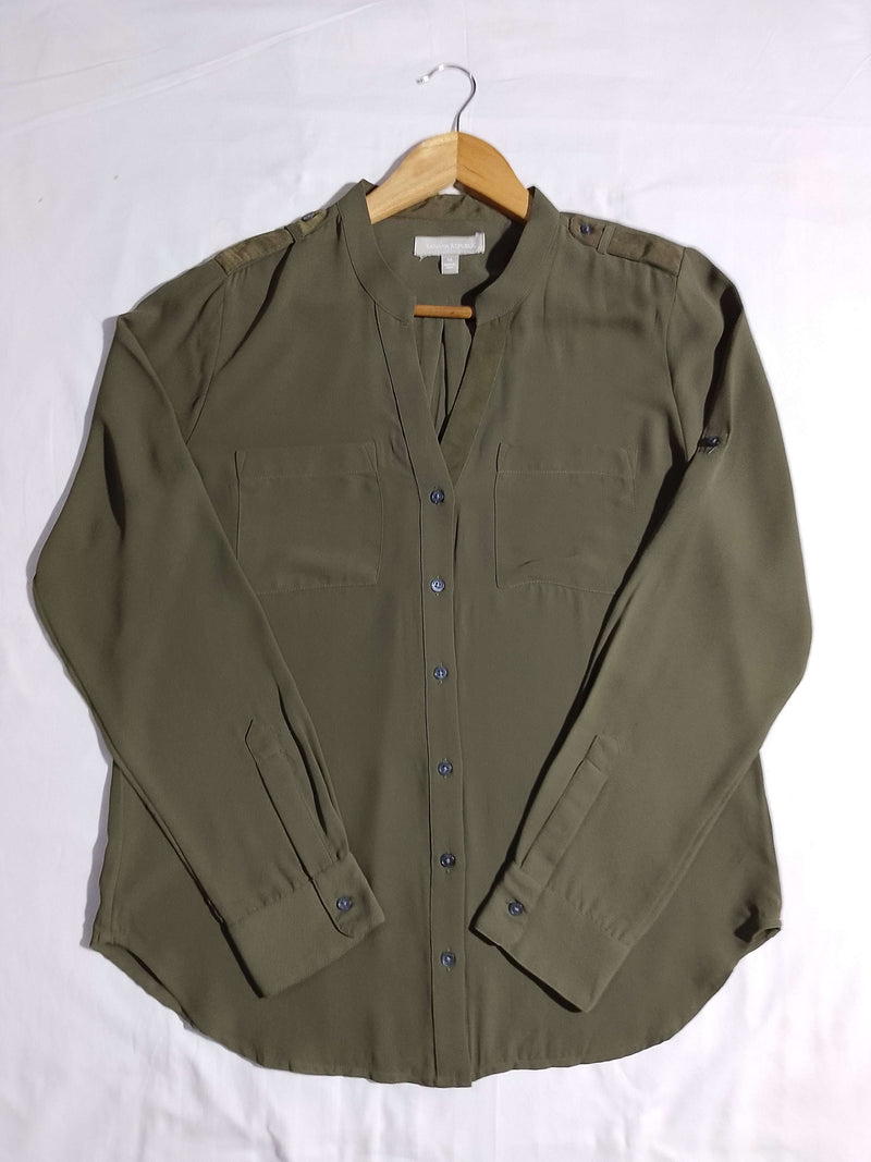 Green shirt on a hanger against a white background