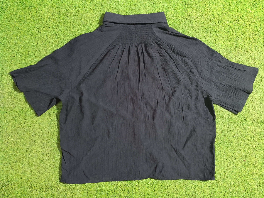Black dress on a green grass background - alternate view