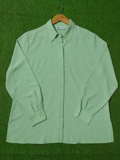 Light green shirt on a hanger against a green background