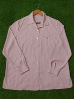 Pink shirt on a green surface