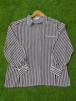 Black and white striped shirt on a green grass background