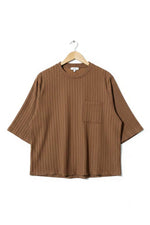 Brown shirt on a hanger against a green textured background