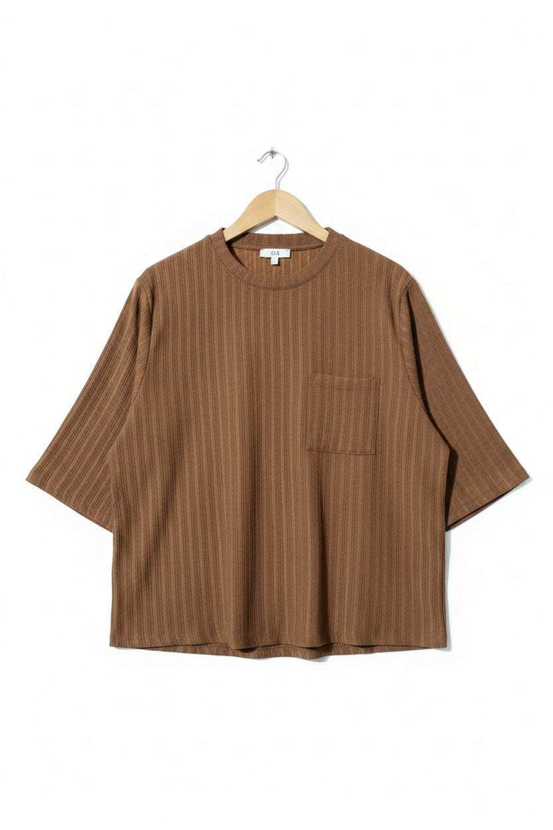 Brown shirt on a hanger against a green textured background