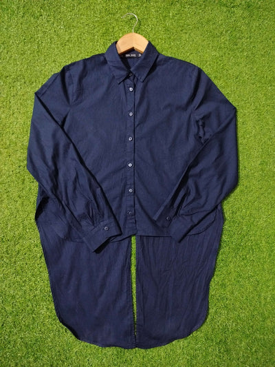 Navy blue shirt on a hanger against a green grass background