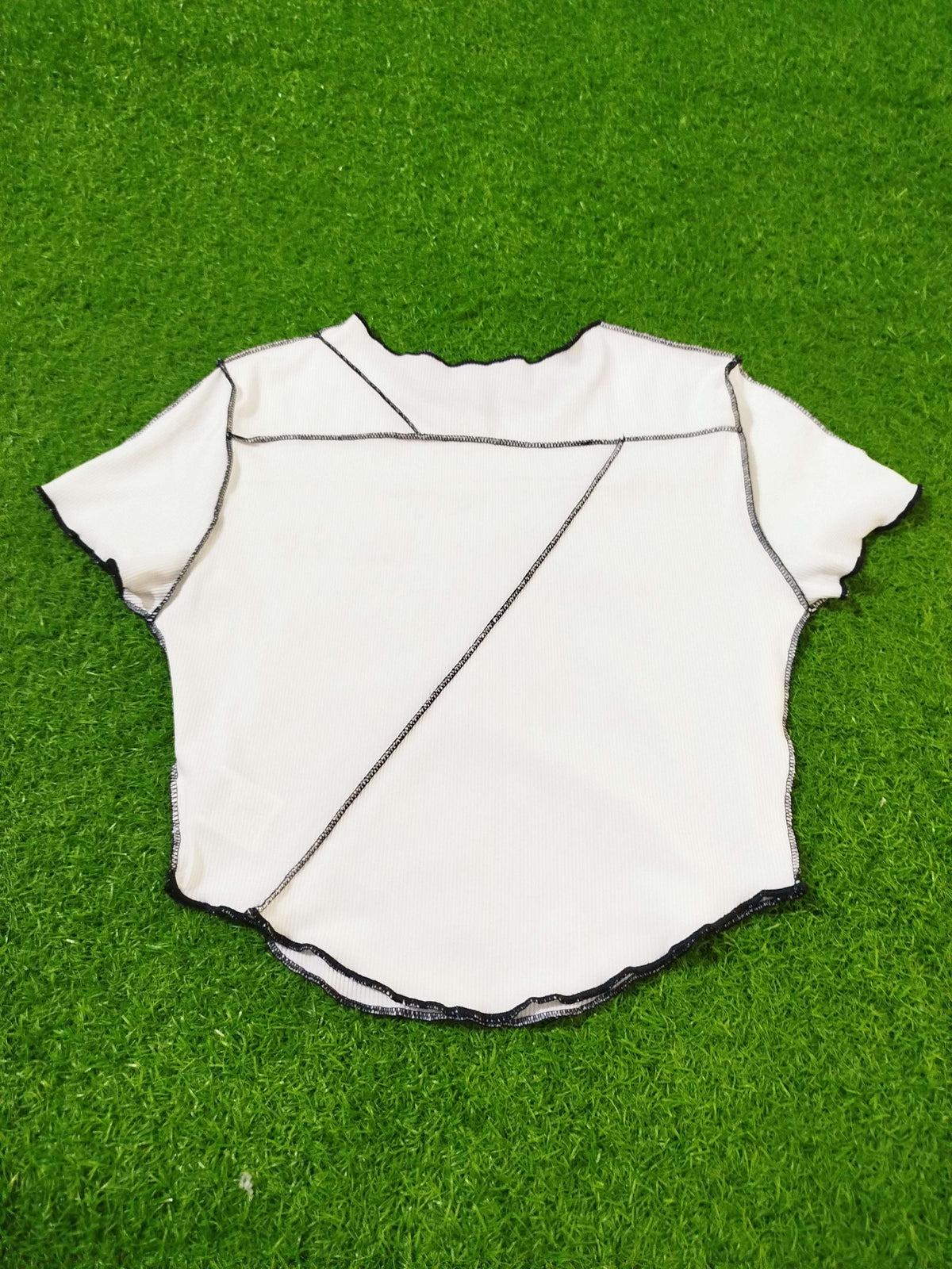 White baseball jersey on a green grass background