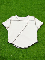 White baseball jersey on a green grass background
