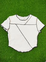White fabric with black lines on a green grass background