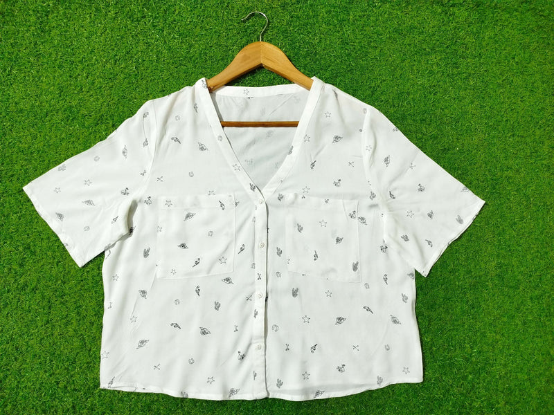 White fabric with small patterns on a green background