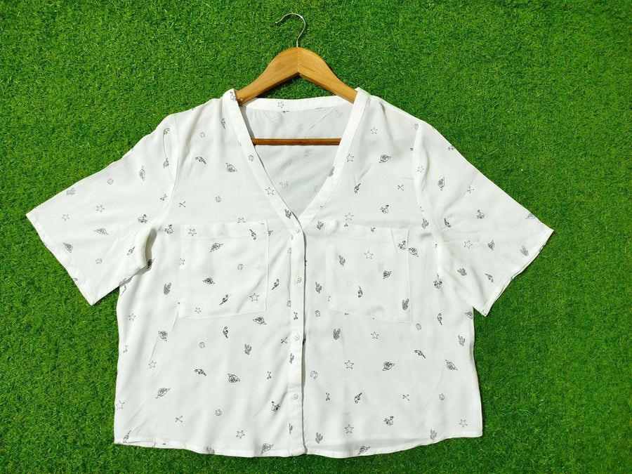 White fabric with small patterns on a green background - alternate view