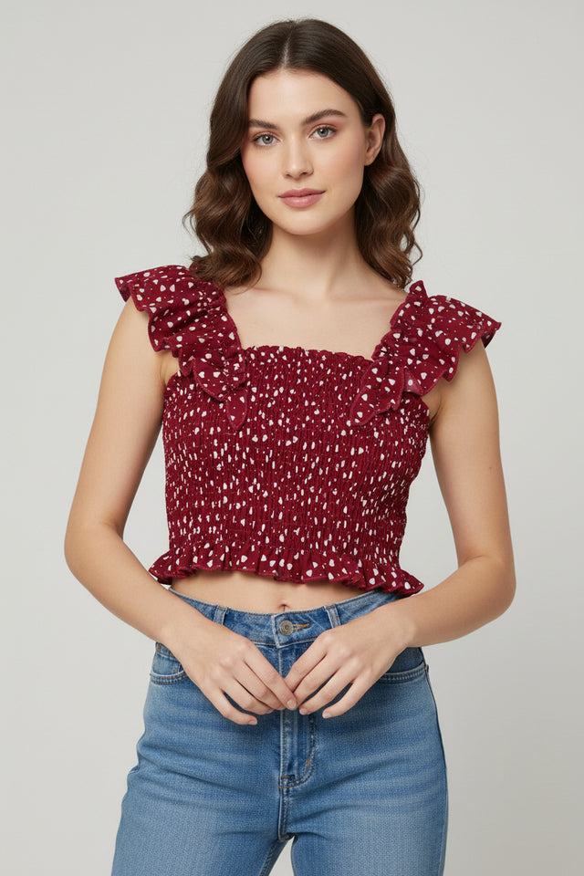 Red floral top with ruffled straps on a green grass background
