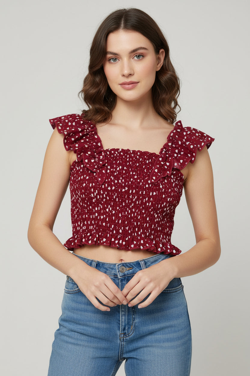 Red floral top with ruffled straps on a green grass background