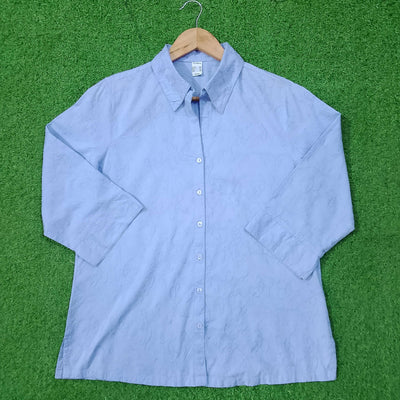 Blue button-up shirt on a green surface