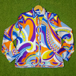 Colorful patterned jacket on a green grass background