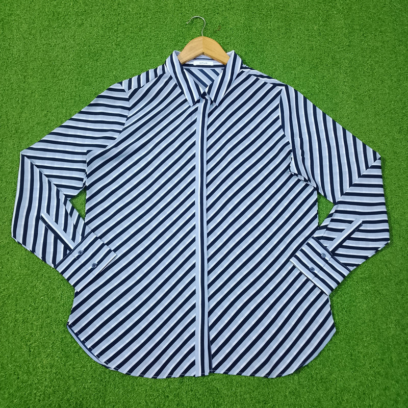 Blue and white striped shirt on a green background