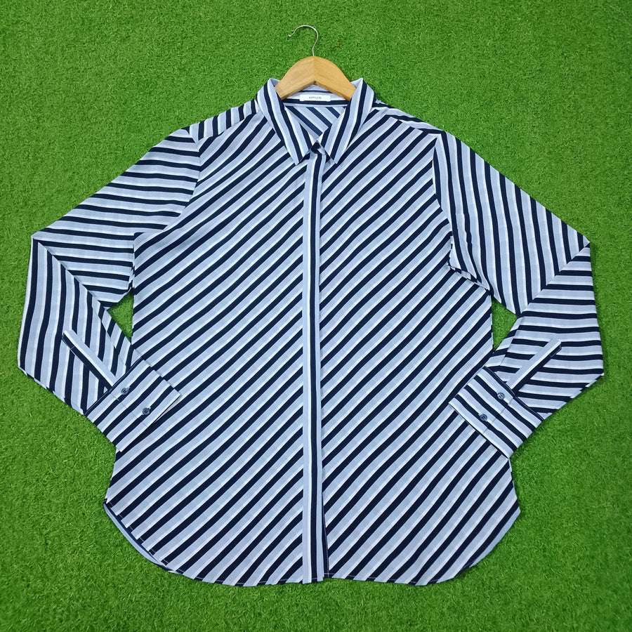 Blue and white striped shirt on a green background - alternate view