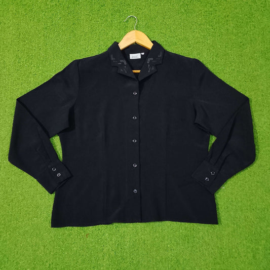 Black shirt on a hanger against a green grass-like background