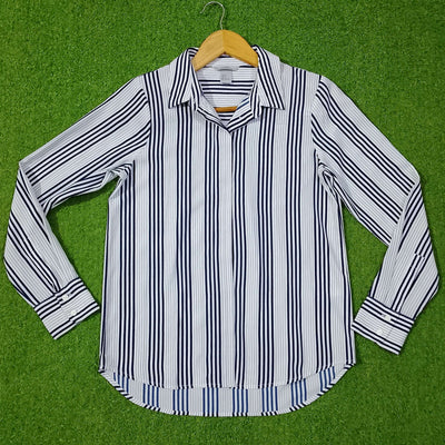 Striped shirt on a hanger against a green background