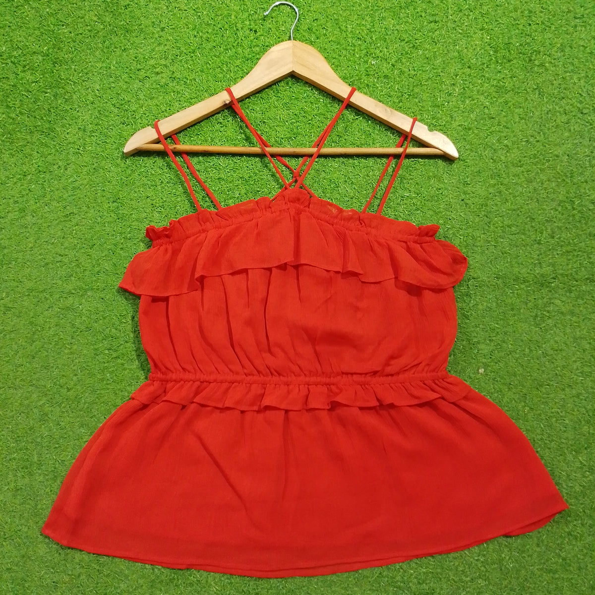 Red off-shoulder ruffle criss-cross strap peplum top - front view