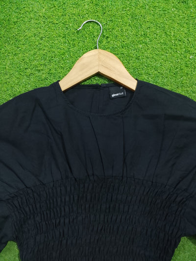 Black smocked drop shoulder flared sleeve crop top - neckline and smocking detail - alternate view