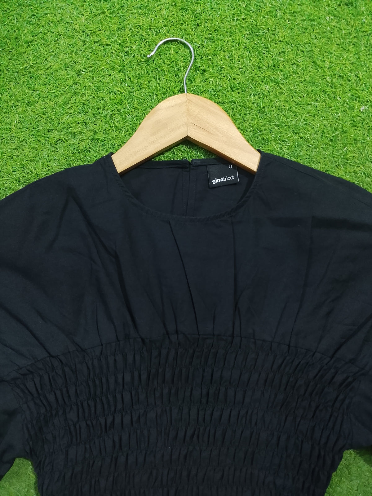 Black smocked drop shoulder flared sleeve crop top - neckline and smocking detail