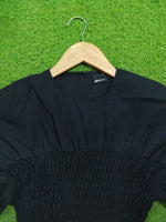Black smocked drop shoulder flared sleeve crop top - neckline and smocking detail