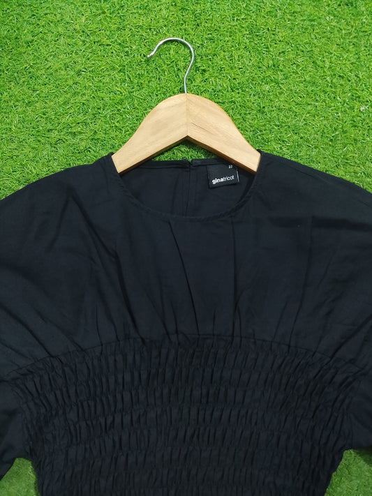 Black smocked drop shoulder flared sleeve crop top - neckline and smocking detail - alternate view