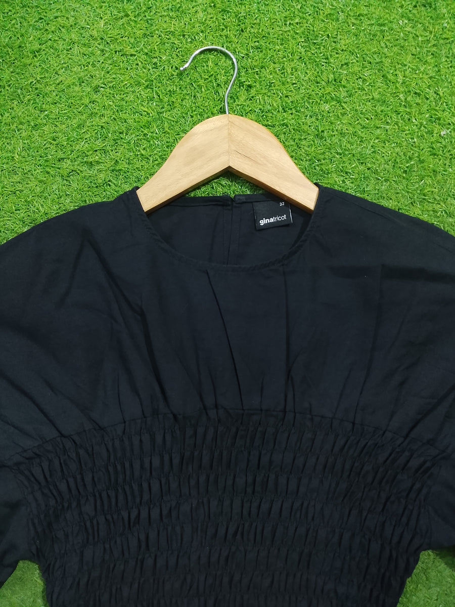 Black smocked drop shoulder flared sleeve crop top - neckline and smocking detail - alternate view