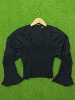 Black smocked drop shoulder flared sleeve crop top - full front flat lay