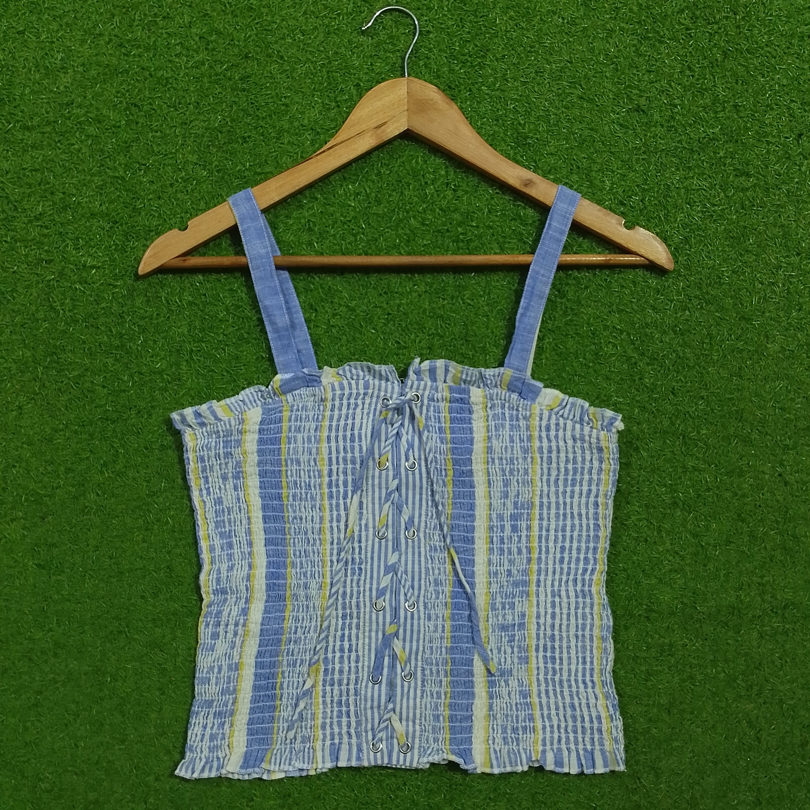 Blue striped smocked lace-up crop top - front view on hanger