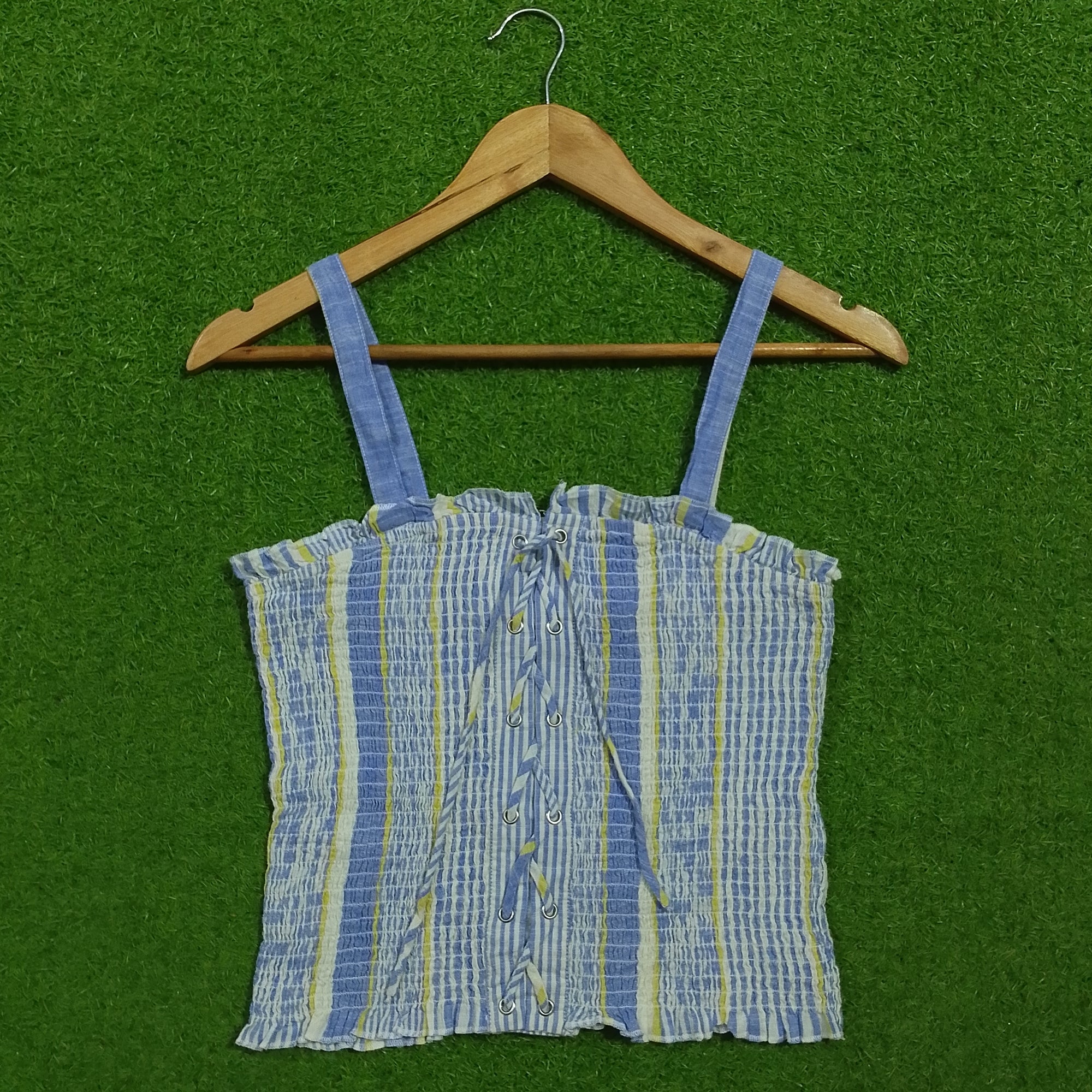 Blue striped smocked lace-up crop top - front view on hanger