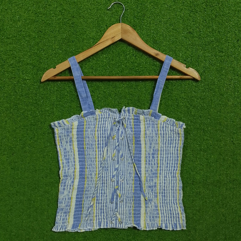 Blue striped smocked lace-up crop top - front view on hanger