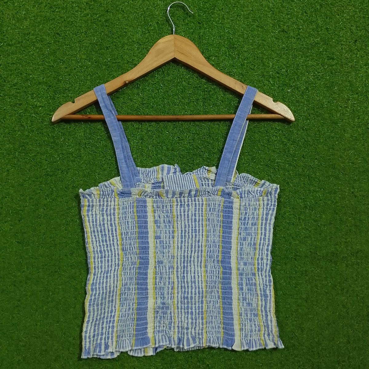Blue striped smocked lace-up crop top - back view on hanger