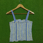 Blue striped smocked lace-up crop top - back view on hanger